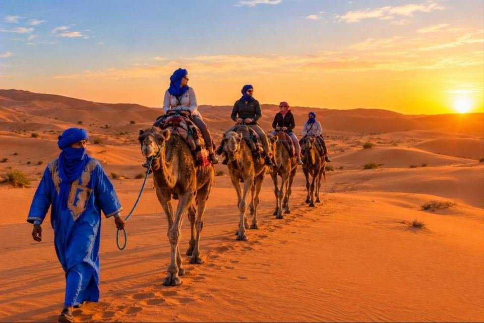 Camel caravan crossing the golden Merzouga Sahara dunes on a 3-day desert tour from Fes, Morocco