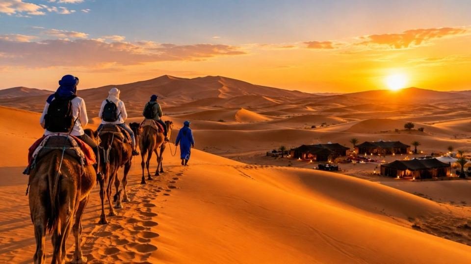 Camel caravan crossing the golden Erg Chebbi dunes at sunset near Merzouga, Morocco